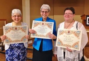 Sr. Sarah Deeby (from left), Sr. Barbara Kennedy, and Sr. Lisa Sheridan hold the Papal blessings they received as part of the 30th Anniversary Celebration of NCC.