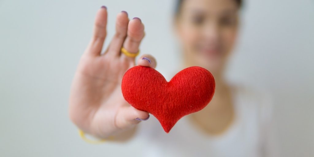 woman holding felt heart